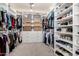 This walk-in closet offers ample storage with custom shelving, drawers, and hanging space at 21266 S 213Th Pl, Queen Creek, AZ 85142