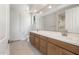 Bathroom with double vanity, quartz countertop, and large mirror at 21296 N 270Th Dr, Buckeye, AZ 85396
