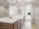 Bathroom with double vanity, quartz countertop, and glass enclosed shower at 21296 N 270Th Dr, Buckeye, AZ 85396