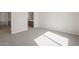 Neutral bedroom with carpeted floors leading to bathroom; kitchen access on left at 21296 N 270Th Dr, Buckeye, AZ 85396