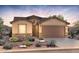 Charming home featuring a desert landscaped yard and a two car garage at 21296 N 270Th Dr, Buckeye, AZ 85396