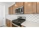 Modern kitchen with stainless steel appliances, white countertops, and stylish backsplash at 21296 N 270Th Dr, Buckeye, AZ 85396