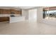 This is a view of the open concept kitchen with stainless steel appliances, tile backsplash, and an island at 21296 N 270Th Dr, Buckeye, AZ 85396