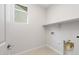 This is a view of the laundry room with connections for a washer and dryer with plenty of shelving at 21296 N 270Th Dr, Buckeye, AZ 85396