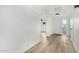 Inviting entryway featuring sleek hardwood floors, a bright white door, and modern lighting fixtures at 220 N 22Nd Pl # 2041, Mesa, AZ 85213