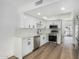 Bright kitchen with white cabinets, stainless steel appliances, subway tile backsplash, and hardwood floors at 220 N 22Nd Pl # 2041, Mesa, AZ 85213