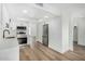Modern kitchen with white cabinets, stainless steel appliances, quartz countertops, and hardwood flooring at 220 N 22Nd Pl # 2041, Mesa, AZ 85213