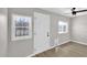 A back room has vinyl floors, three windows, and a white door with new fixtures at 2234 W Mohawk Ln, Phoenix, AZ 85027