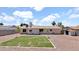 View of rear exterior of the home with low maintenance yard and storage shed at 2234 W Mohawk Ln, Phoenix, AZ 85027