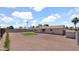 View of rear exterior of home featuring low maintenance gravel yard with bordered grass at 2234 W Mohawk Ln, Phoenix, AZ 85027