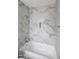 Modern bathroom features marble-style tiling in the shower and integrated shower niche at 2234 W Mohawk Ln, Phoenix, AZ 85027
