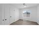 A clean bedroom featuring vinyl floors, a window, a closet door, and neutral walls at 2234 W Mohawk Ln, Phoenix, AZ 85027