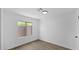 An empty bedroom offers neutral walls, vinyl floors and a window that provides natural light at 2234 W Mohawk Ln, Phoenix, AZ 85027