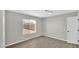 This bedroom features neutral walls, vinyl floors, and a window providing natural light at 2234 W Mohawk Ln, Phoenix, AZ 85027