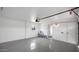 A clean garage features an epoxy floor, a window, and a doorway leading to the house at 2234 W Mohawk Ln, Phoenix, AZ 85027