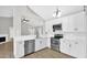 Kitchen with stainless steel appliances, white cabinets, and wood-look flooring at 2234 W Mohawk Ln, Phoenix, AZ 85027