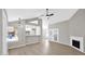 Cozy living room with a fireplace, modern ceiling fan, and lots of natural light at 2234 W Mohawk Ln, Phoenix, AZ 85027