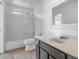 Bright bathroom featuring a shower-tub combo, white vanity, and neutral tile flooring at 2262 E Javelina Ave, Mesa, AZ 85204