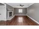 Open-concept living room with hardwood floors, gray walls and a charming brick fireplace at 2262 E Javelina Ave, Mesa, AZ 85204