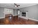 Open-concept living room with hardwood floors, gray walls, brick fireplace at 2262 E Javelina Ave, Mesa, AZ 85204