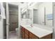 Bathroom featuring a vanity with a white countertop and a walk-in shower at 2433 E Acoma Dr, Phoenix, AZ 85032
