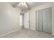 A bedroom featuring a ceiling fan, a standard closet, and neutral walls at 2433 E Acoma Dr, Phoenix, AZ 85032