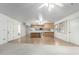Open-concept living area, kitchen with light wood cabinets and island at 2433 E Acoma Dr, Phoenix, AZ 85032