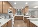 Bright kitchen featuring wood cabinets, white countertops, and modern appliances at 2433 E Acoma Dr, Phoenix, AZ 85032