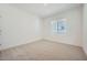 Bright bedroom featuring neutral carpet, white walls, and a window offering lots of natural light at 25188 N 174Th Ave, Surprise, AZ 85387