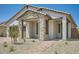 Charming home featuring a stone facade, covered porch, and low-maintenance landscaping, creating inviting curb appeal at 25188 N 174Th Ave, Surprise, AZ 85387