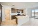 Modern kitchen with a center island, stainless steel appliances, pendant lighting, and seamless access to outdoor space at 25188 N 174Th Ave, Surprise, AZ 85387