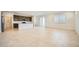 Bright open-concept living space with tile flooring, abundant natural light, and seamless kitchen access at 25188 N 174Th Ave, Surprise, AZ 85387