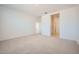 Bright main bedroom with neutral carpet and en-suite bathroom featuring white walls at 25188 N 174Th Ave, Surprise, AZ 85387