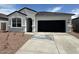 Charming single-story home featuring a two-car garage and low-maintenance desert landscaping at 25251 N 183Rd Dr, Wittmann, AZ 85361