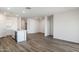 Open-concept living room with sleek floors and ample space, adjacent to a modern kitchen at 25251 N 183Rd Dr, Wittmann, AZ 85361