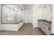Modern bathroom boasts a glass shower, gray tile floors, and stylish vanity at 27046 W Rockwood Dr, Buckeye, AZ 85396
