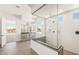 Modern bathroom boasts a glass shower, gray tile floors, and stylish vanity at 27046 W Rockwood Dr, Buckeye, AZ 85396
