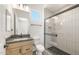 A modern bathroom featuring a walk-in shower with a black frame and a single sink vanity at 27046 W Rockwood Dr, Buckeye, AZ 85396