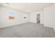 Bright bedroom with gray carpet, white walls, and natural light from scenic view at 27046 W Rockwood Dr, Buckeye, AZ 85396