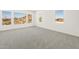 A bedroom with carpet floors and mountain views through the windows at 27046 W Rockwood Dr, Buckeye, AZ 85396