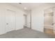 A neutral bedroom with access to an en suite bathroom and two separate closets at 27046 W Rockwood Dr, Buckeye, AZ 85396