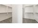 Walk-in closet featuring ample shelving, carpet flooring and white walls at 27046 W Rockwood Dr, Buckeye, AZ 85396