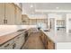 Well-equipped kitchen featuring stainless appliances, light wood cabinetry, granite countertops and tile backsplash at 27046 W Rockwood Dr, Buckeye, AZ 85396