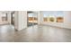 Open-concept living area with tile flooring and sliding glass doors leading to the outdoor space and picturesque desert views at 27046 W Rockwood Dr, Buckeye, AZ 85396