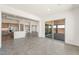 The open living space leads to a modern kitchen with stone counters and stainless steel appliances, perfect for entertaining at 27046 W Rockwood Dr, Buckeye, AZ 85396