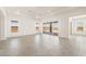 Expansive living room boasts tile floors, recessed lighting, and sliding glass doors to the outdoor living space at 27046 W Rockwood Dr, Buckeye, AZ 85396