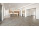 Spacious open-concept living area and kitchen with large tile flooring and bright lighting at 27046 W Rockwood Dr, Buckeye, AZ 85396