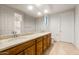 Bathroom featuring double sinks with granite countertops and wood cabinets at 27110 W Adam Ave, Buckeye, AZ 85396