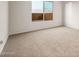 Neutral bedroom with carpet floors and a large window at 27110 W Adam Ave, Buckeye, AZ 85396