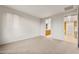 Spacious bedroom with neutral carpet and large opening to the bathroom at 27110 W Adam Ave, Buckeye, AZ 85396